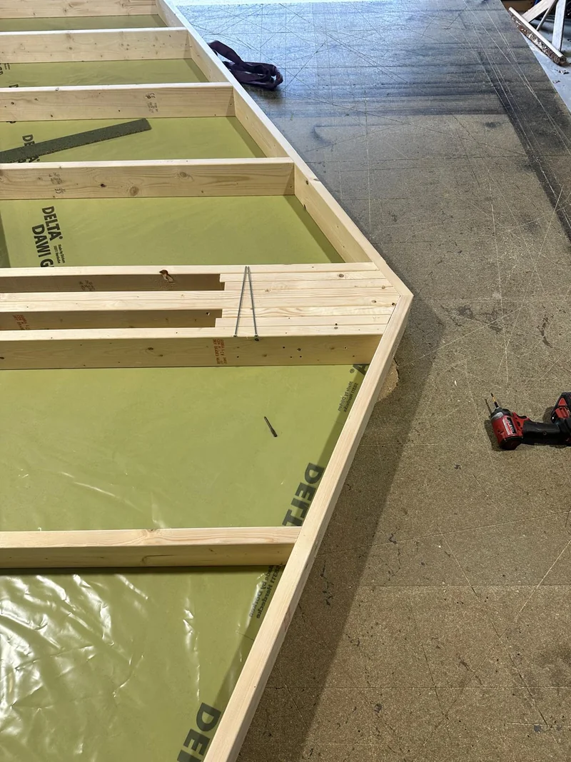Houten frame met gele folie tijdens voorbereiding in de werkplaats